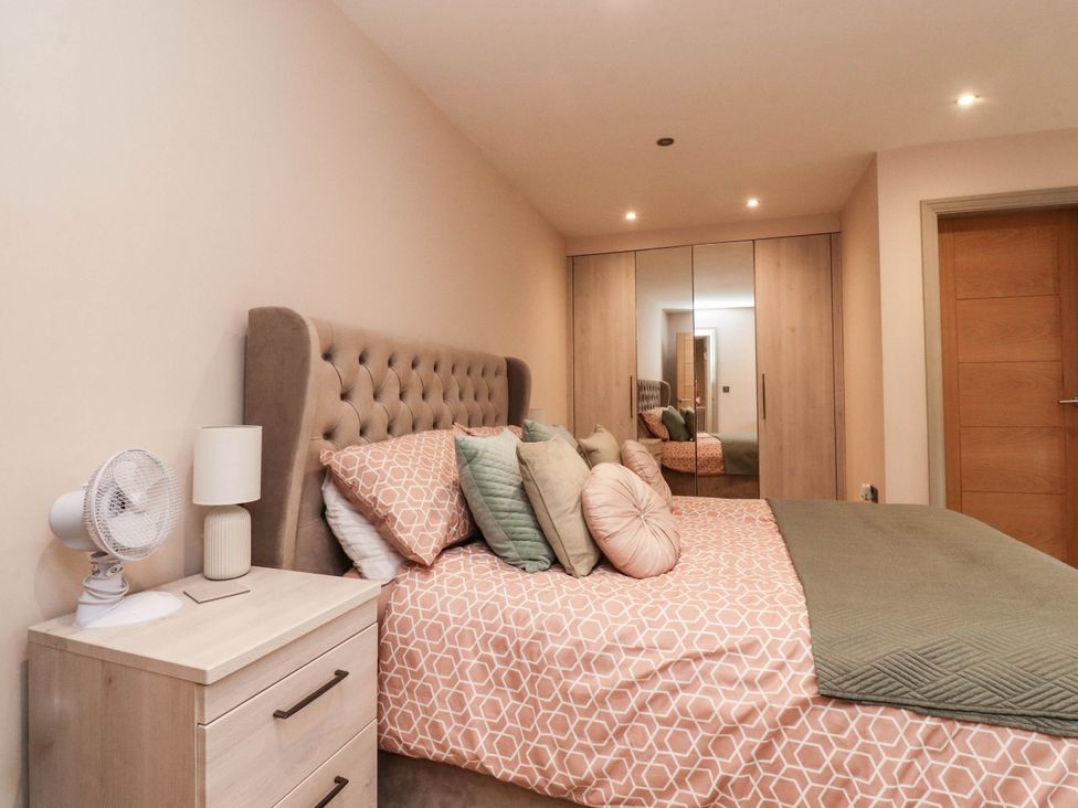 A bedroom with a bed and nightstand at 4 Church Hall Mews Garstang