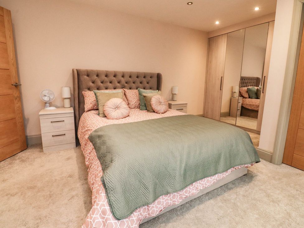 A bedroom with a bed and nightstand at 4 Church Hall Mews in Garstang
