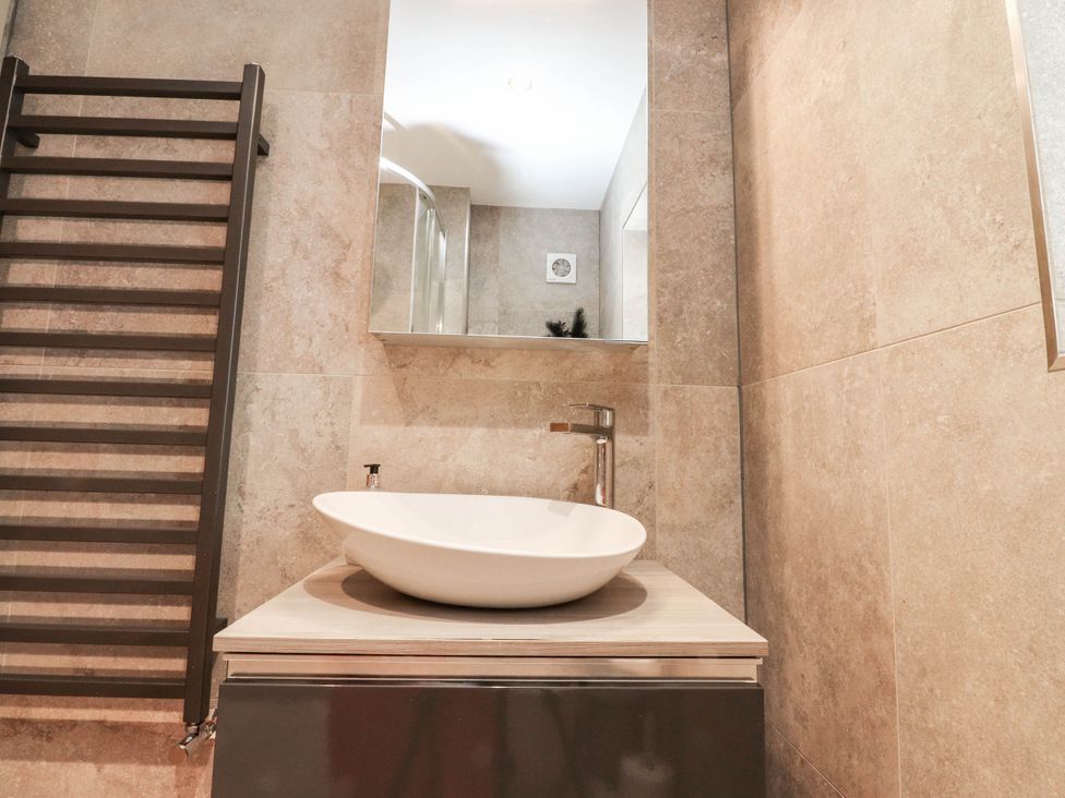 A bathroom with a wash basin and heated towel rail at 4 Church Hall Mews in Garstang