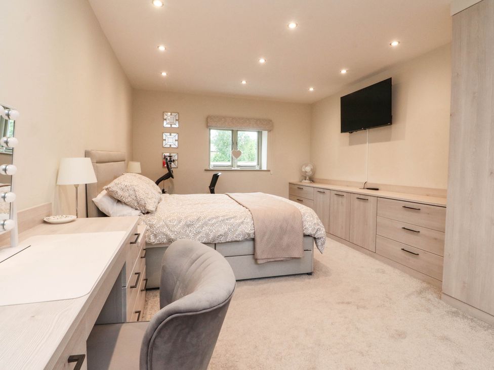 A bedroom with a bed and desk at 4 Church Hall Mews in Garstang