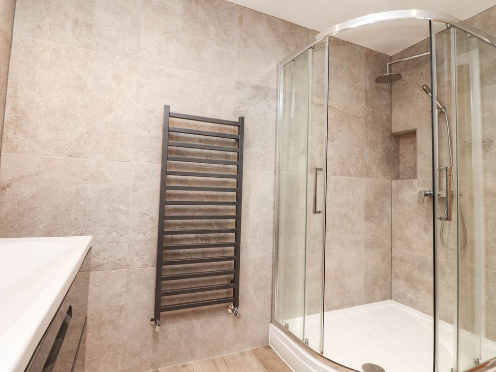 A bathroom featuring a shower and towel radiator at 4 Church Hall Mews Garstang