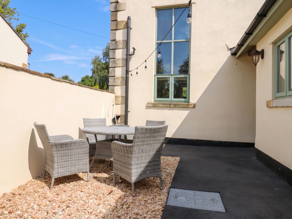 An outdoor patio area with a table and chairs at 4 Church Hall Mews in Garstang