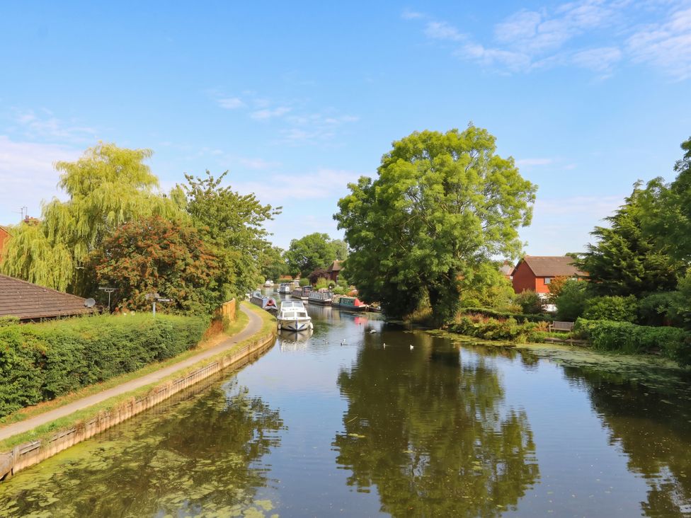 A canal with boats and trees at 4 Church Hall Mews in Garstang