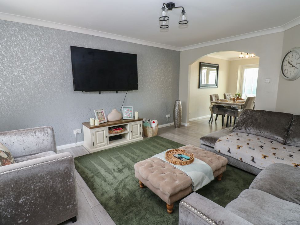 A living room with a television and a coffee table at 4 Murrayfields Newcastle upon Tyne