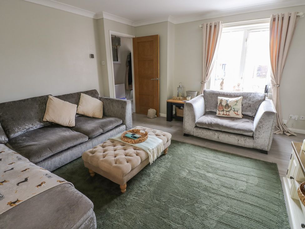 A living room with a sofa and coffee table at 4 Murrayfields Newcastle upon Tyne