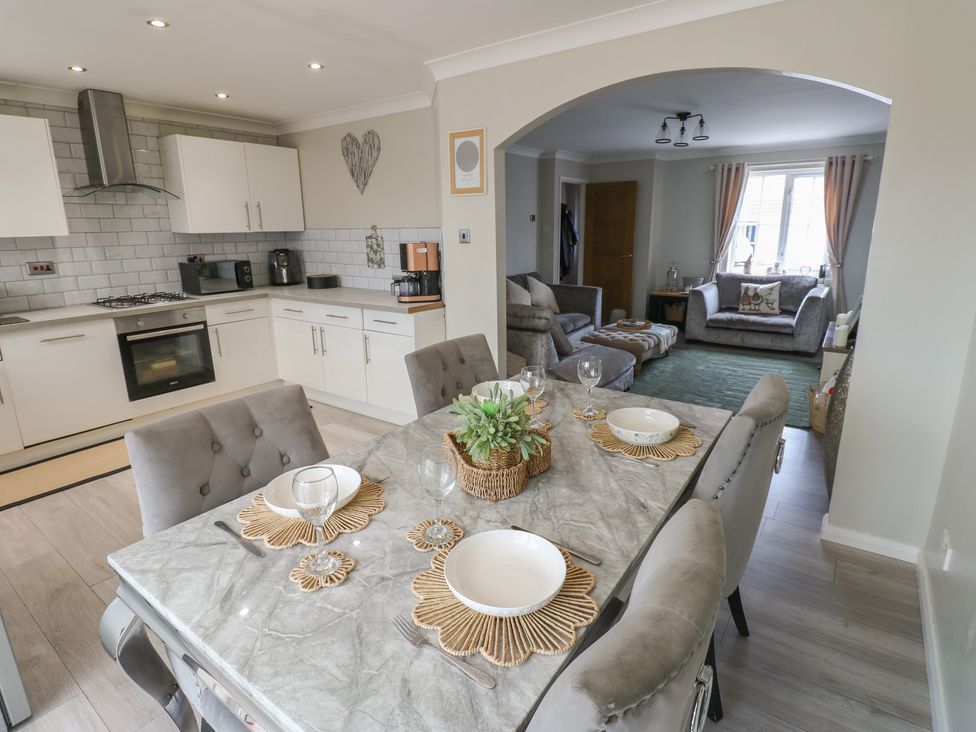 A kitchen and dining area with a table set at 4 Murrayfields Newcastle upon Tyne