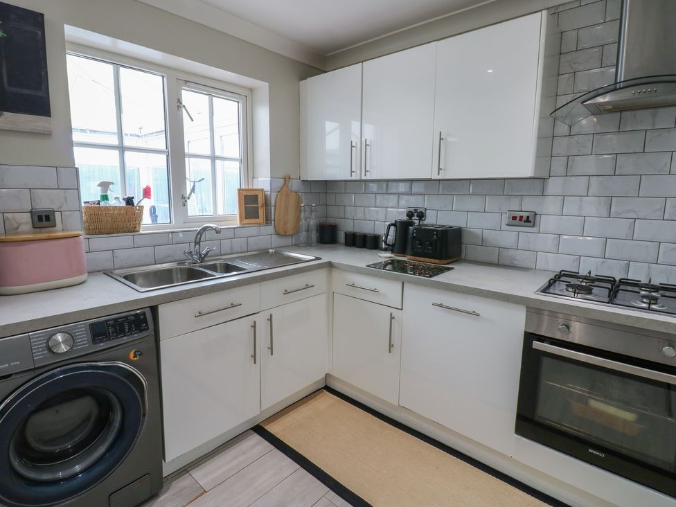 A kitchen with a sink and washing machine at 4 Murrayfields Newcastle upon Tyne
