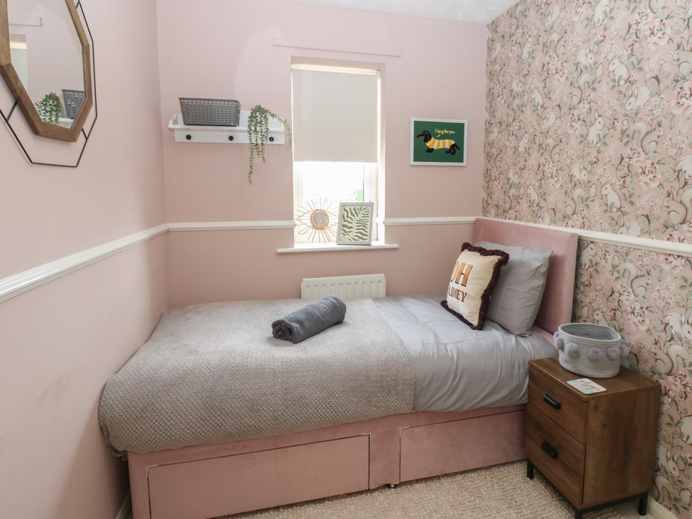 A bedroom with a bed and nightstand at 4 Murrayfields in Newcastle upon Tyne