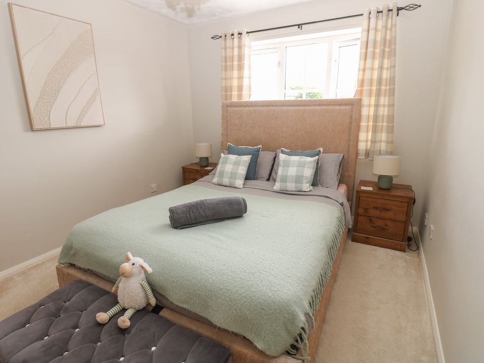 A bedroom with a bed and two nightstands at 4 Murrayfields Newcastle upon Tyne