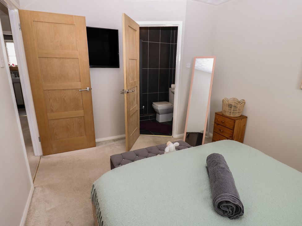 A bedroom with a bed and a mirror at 4 Murrayfields Newcastle upon Tyne