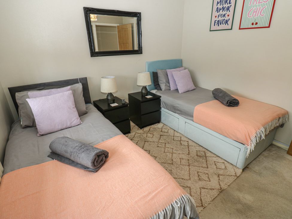 A bedroom with twin beds and lamps at 4 Murrayfields Newcastle upon Tyne