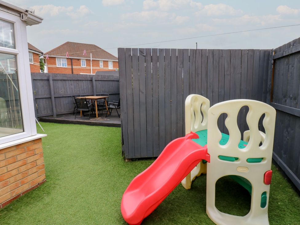 A garden with a slide and seating area at 4 Murrayfields Newcastle upon Tyne