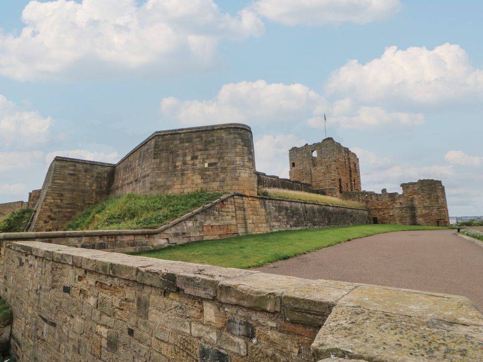 A castle with stone walls and a grassy area at 4 Murrayfields Newcastle upon Tyne