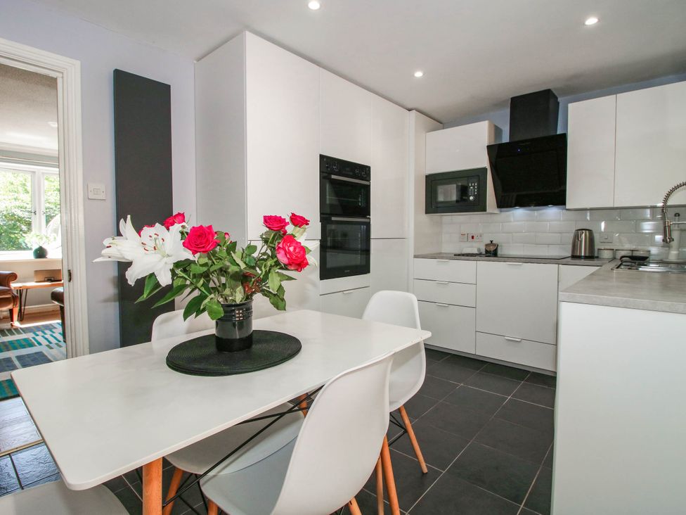 A kitchen with a table and chairs at Lilac Cottage in Ironbridge