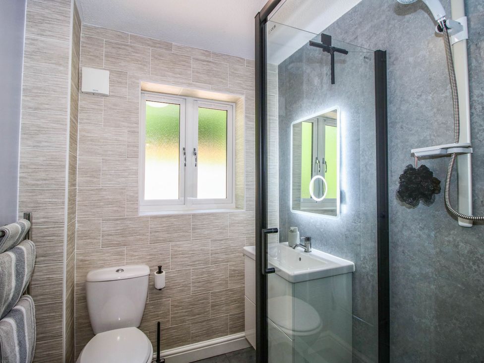 A bathroom with a shower and sink at Lilac Cottage Ironbridge