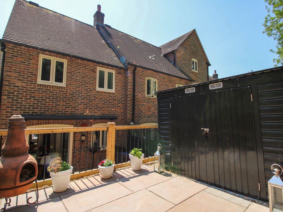 An outdoor area with a shed and planters at Lilac Cottage in Ironbridge