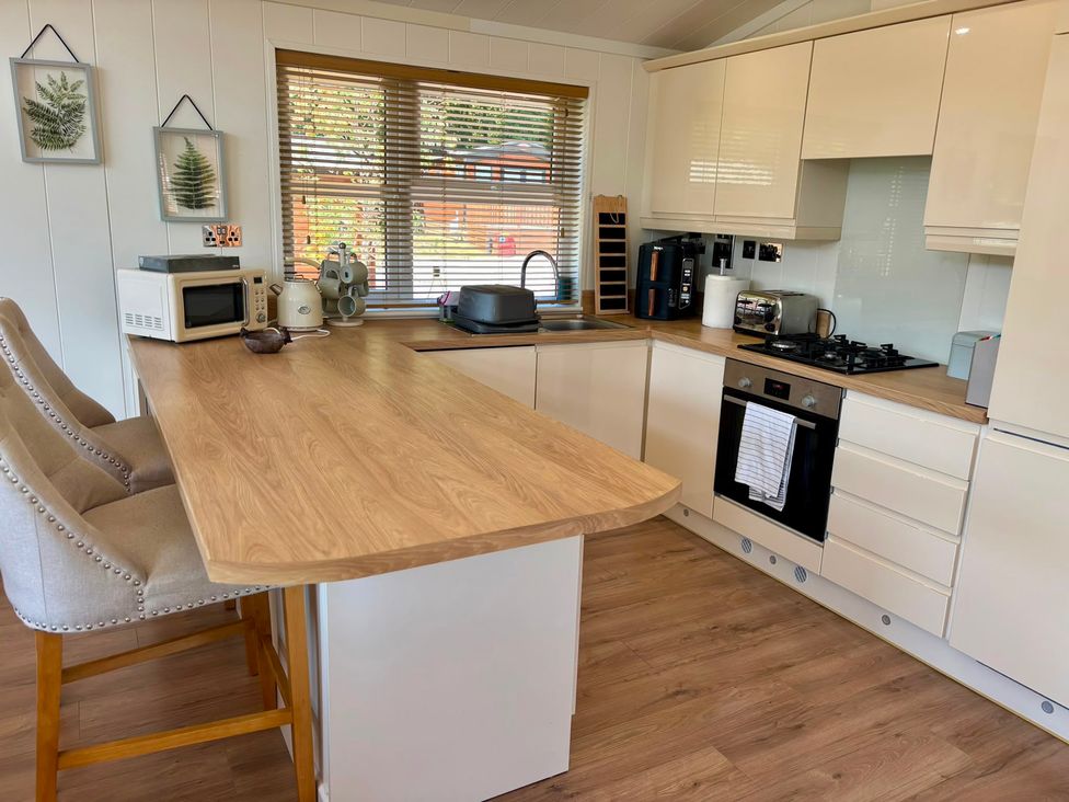 A kitchen with a sink and appliances at Lakeside Retreat in Newton Abbot