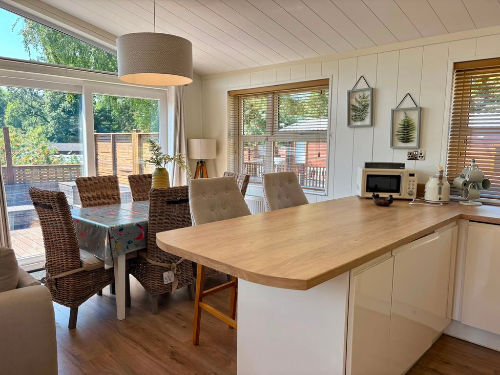 A kitchen with a table and chairs at Lakeside Retreat Newton Abbot