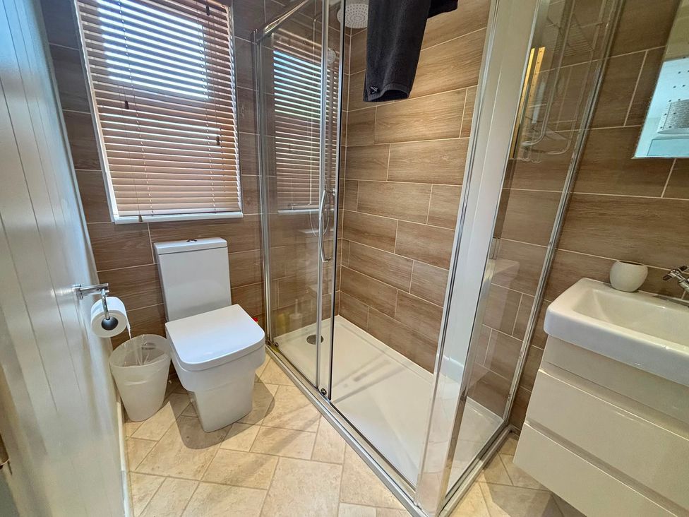 A bathroom with a shower and toilet at Lakeside Retreat in Newton Abbot