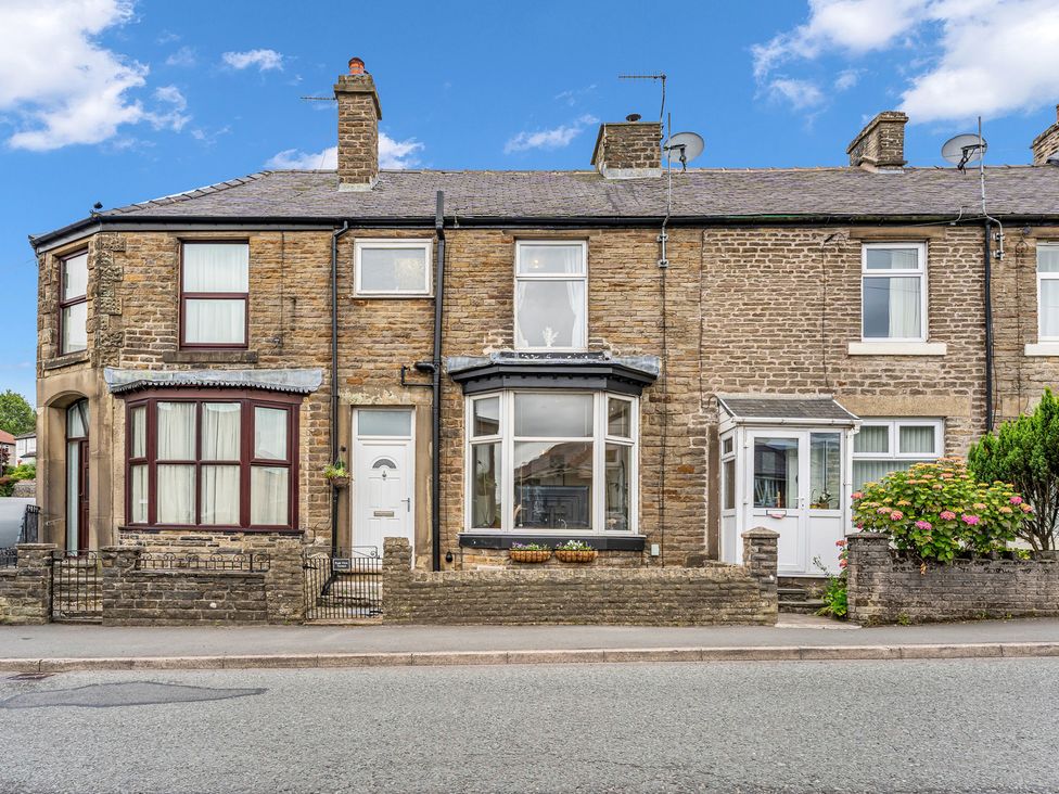 A view of a house with multiple windows and a front garden at Peak View Terrace