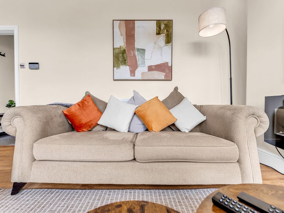 A living room with a sofa and a painting at Peak View Terrace
