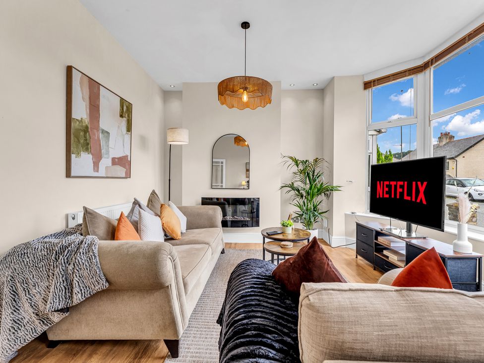 A living room with a sofa and television at Peak View Terrace