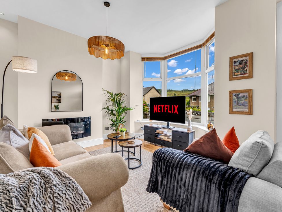 A living room with a television and sofa at Peak View Terrace