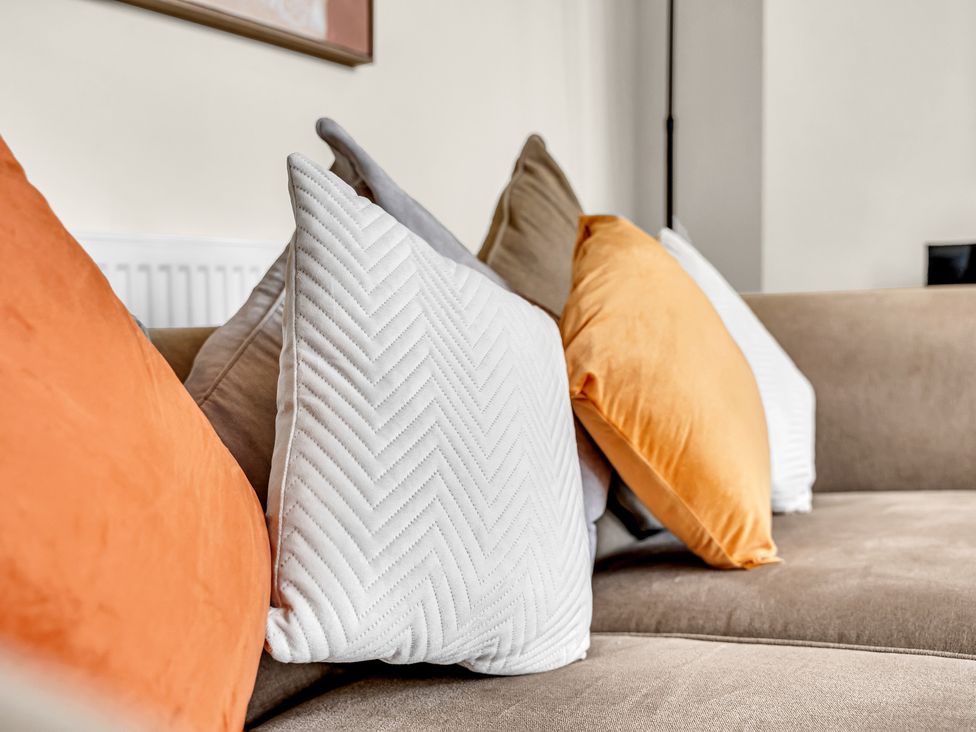 A couch with decorative pillows in a living room at Peak View Terrace