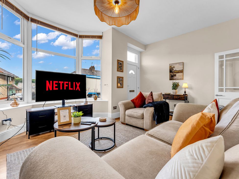 A living room with a television and sofa at Peak View Terrace