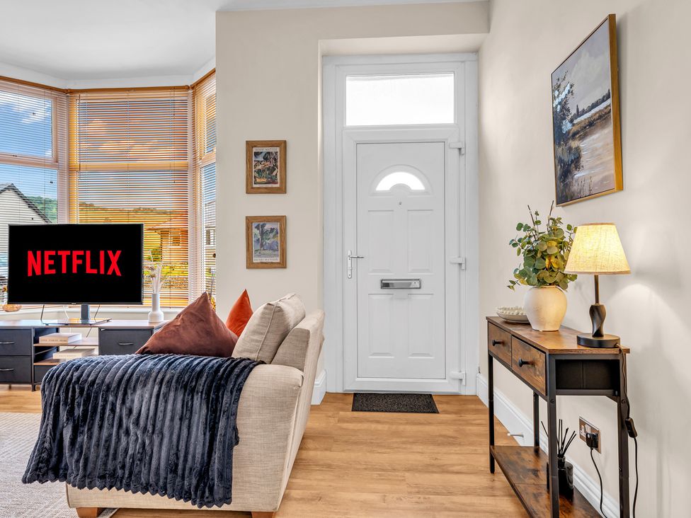 A living room with a television and sofa at Peak View Terrace