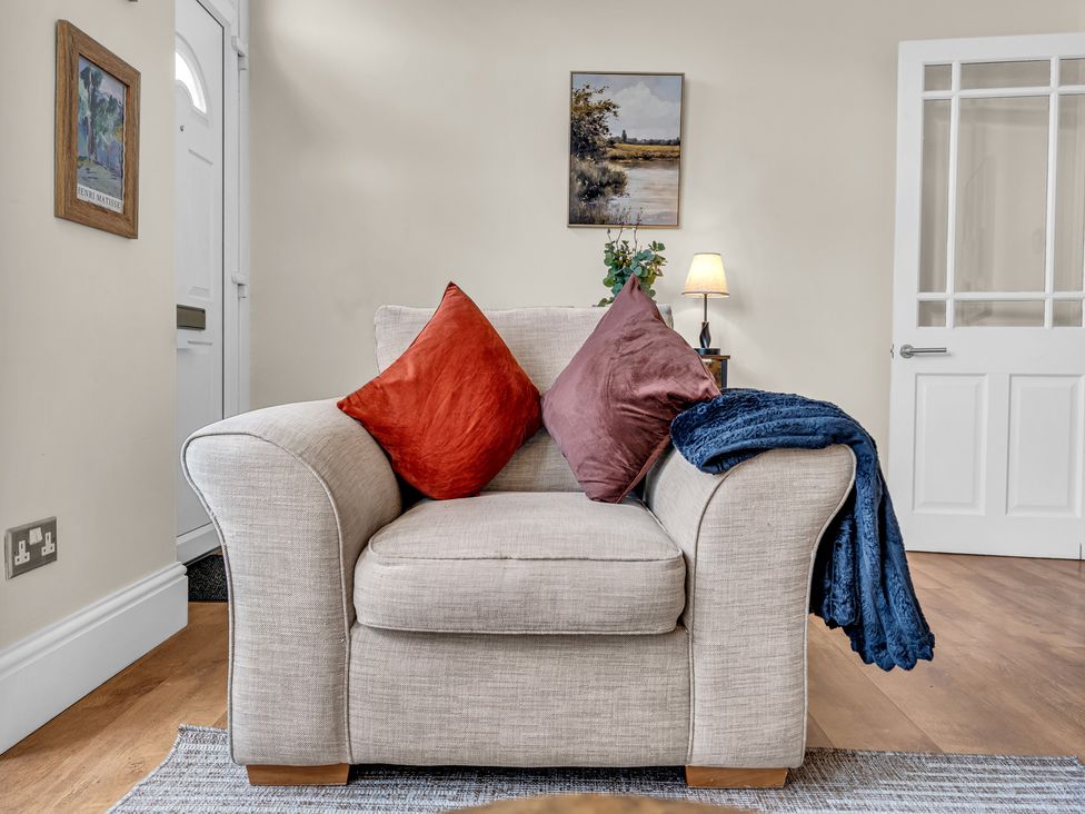 A living room with an armchair and a side table at Peak View Terrace