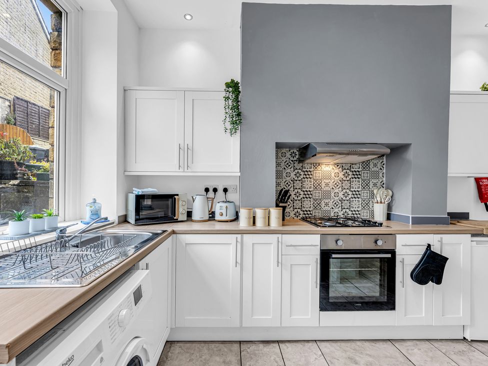 A kitchen with appliances and cabinetry at Peak View Terrace