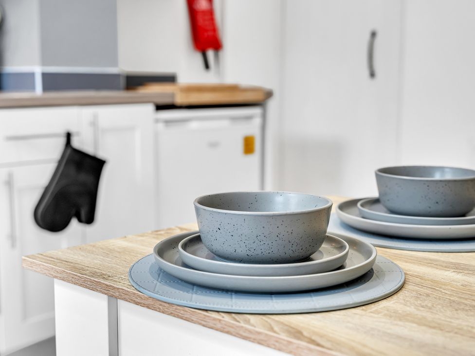A kitchen with plates and bowls on a table at Peak View Terrace