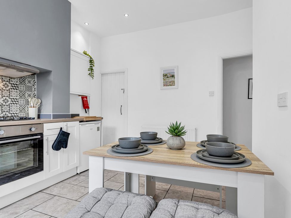 A kitchen with a dining table and plates at Peak View Terrace