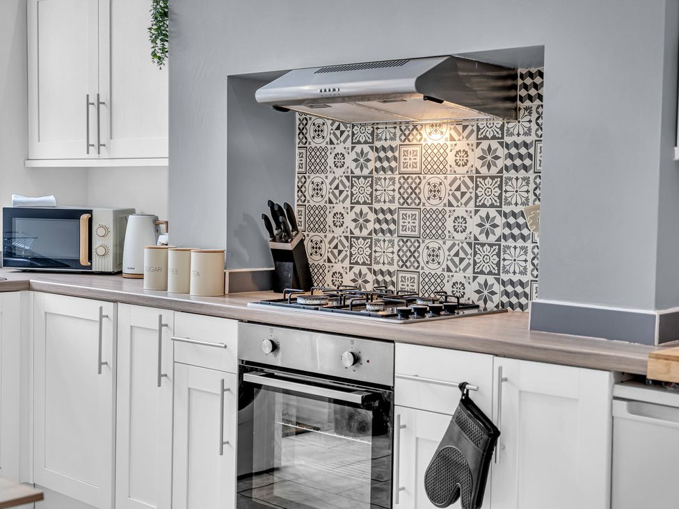 A kitchen with a cooktop and oven at Peak View Terrace