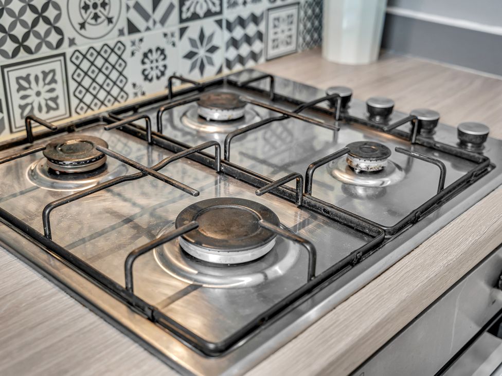 A gas stove with burners and knobs at Peak View Terrace