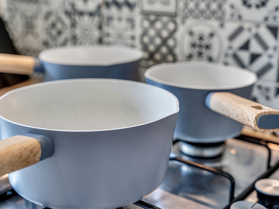 Three cooking pots on a stove in a kitchen at Peak View Terrace