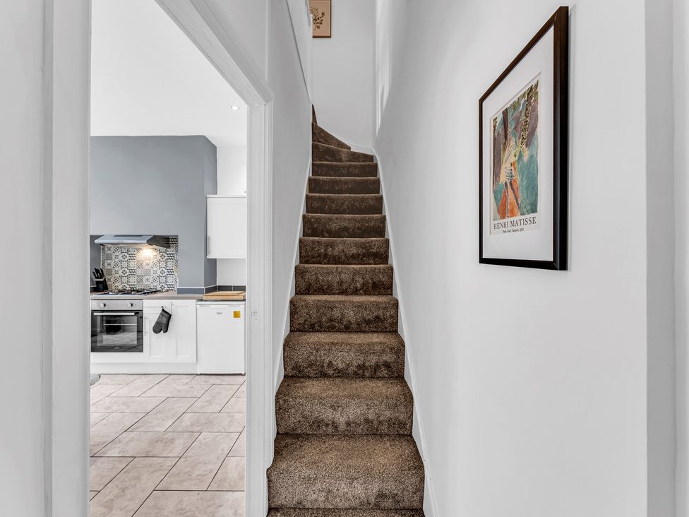 A hallway with stairs leading to an upper floor at Peak View Terrace