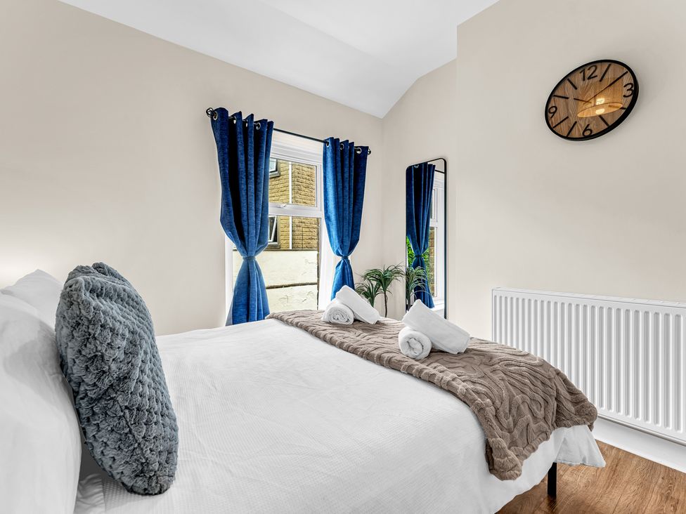 A bedroom with a bed and curtains at Peak View Terrace