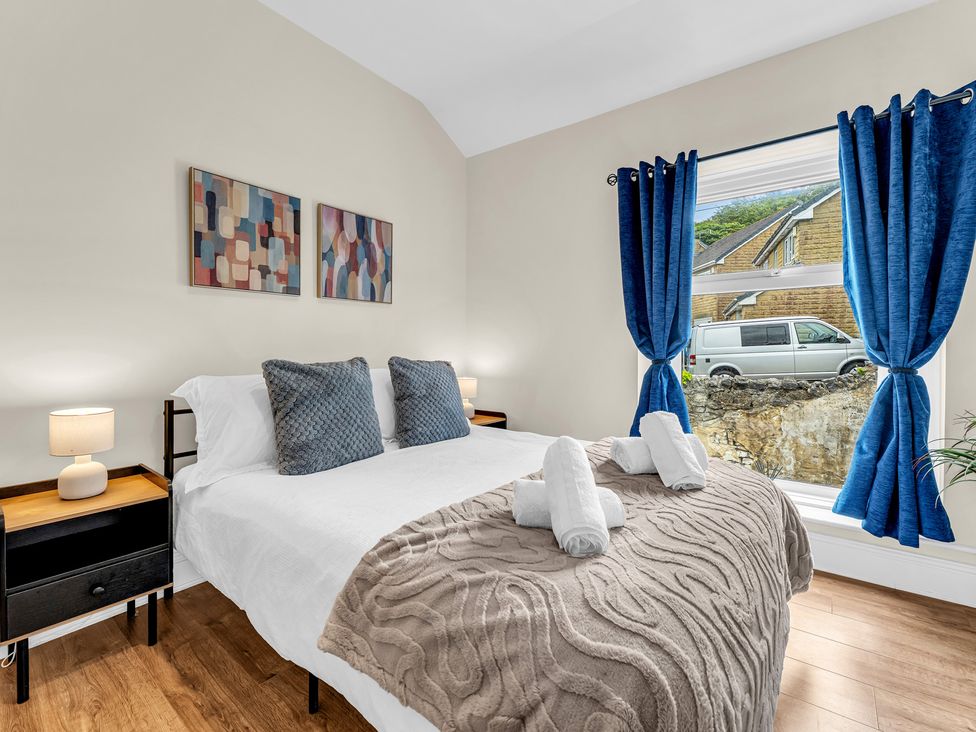 A bedroom with a bed and artwork at Peak View Terrace 
