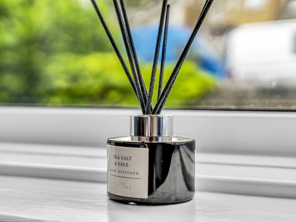 A reed diffuser with a black base and scent sticks at Peak View Terrace