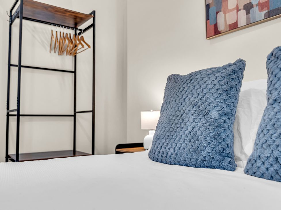A bedroom with pillows and a lamp at Peak View Terrace