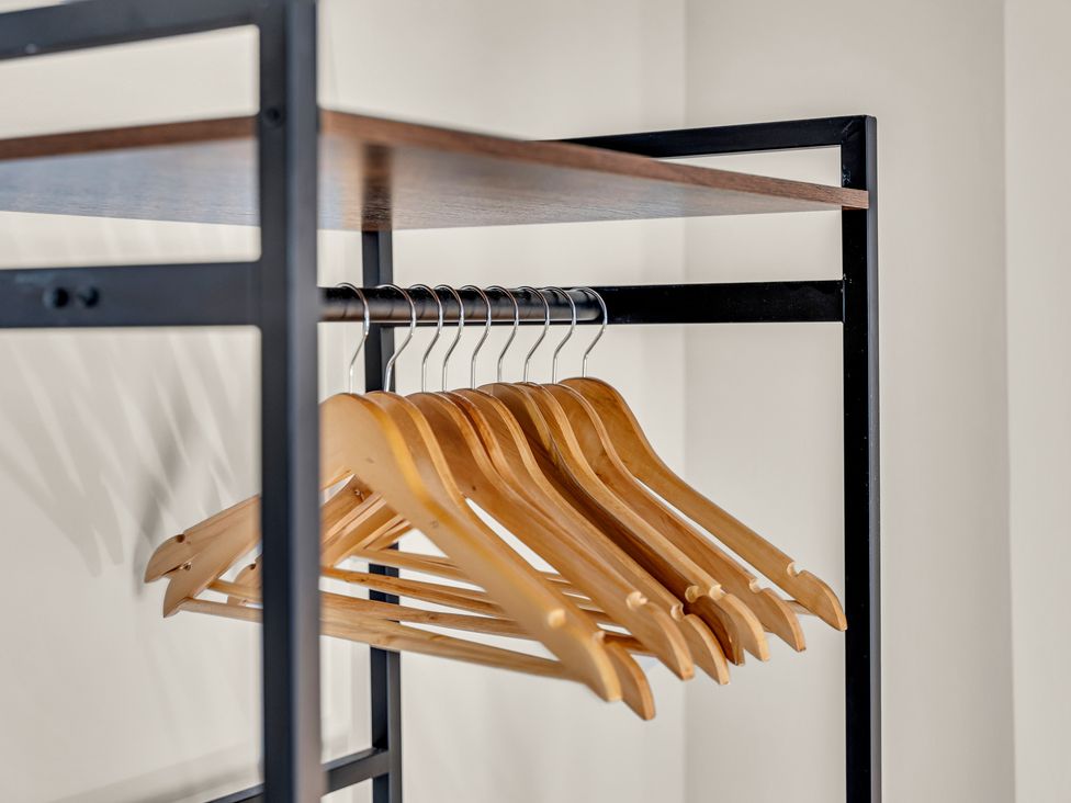 A closet with wooden hangers on a metal rack at Peak View Terrace