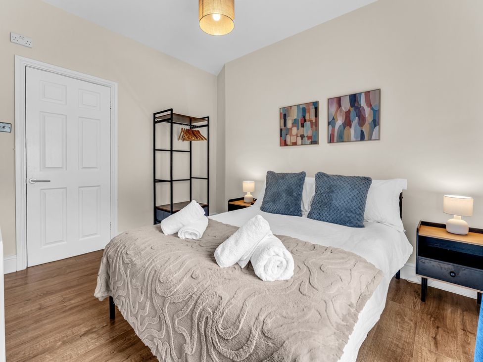 A bedroom with a bed and bedside tables at Peak View Terrace