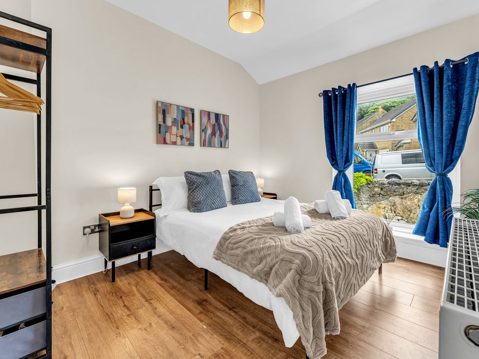 A bedroom with a bed and nightstand at Peak View Terrace