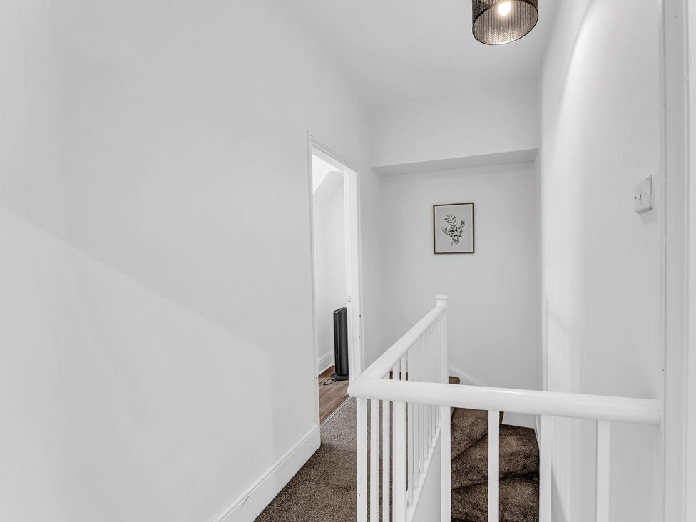 A hallway with a light fixture and a framed artwork at Peak View Terrace