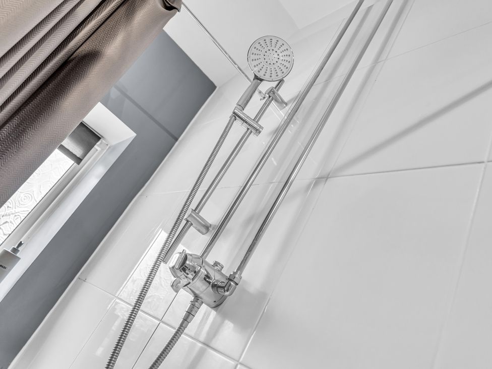 A shower setup with curtain and window at Peak View Terrace