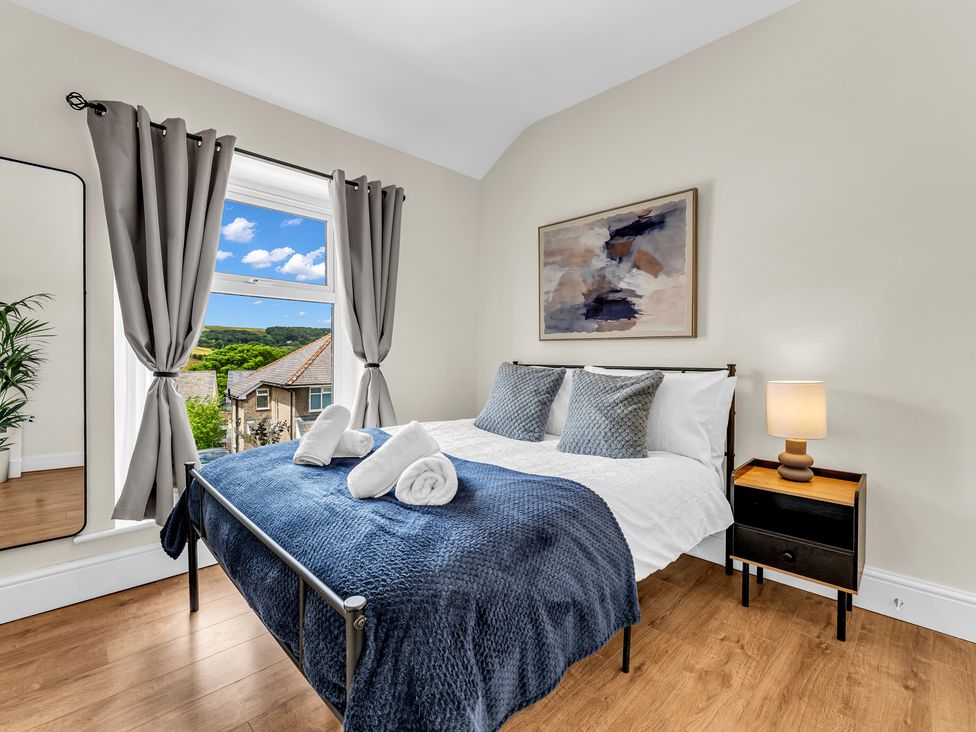 A bedroom with a bed and a window at Peak View Terrace