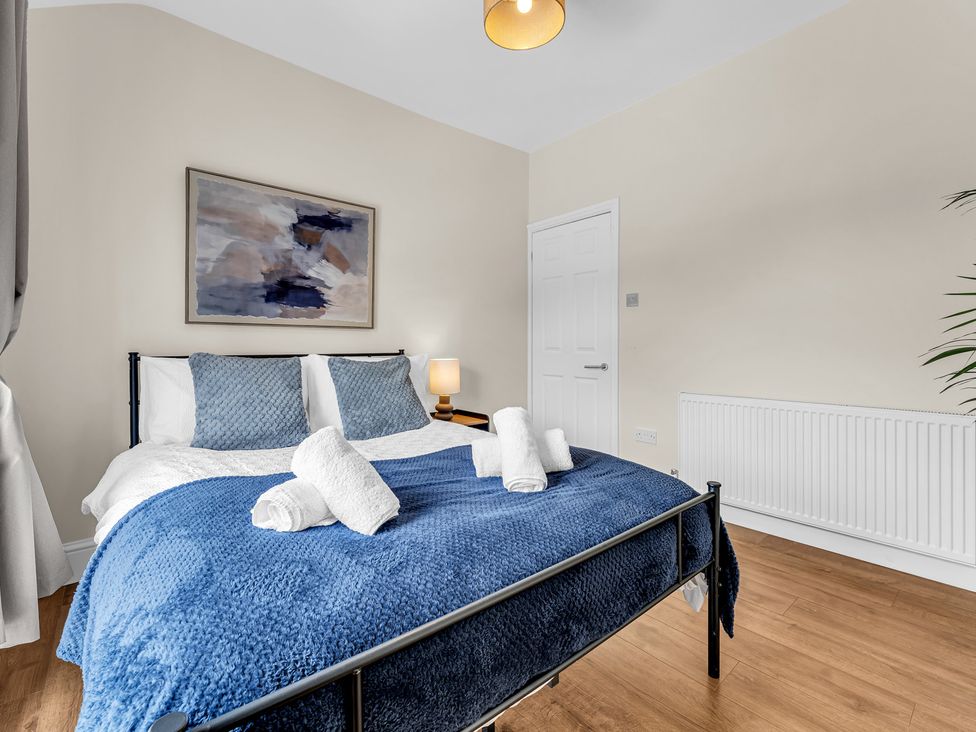 A bedroom with a bed and wall art at Peak View Terrace