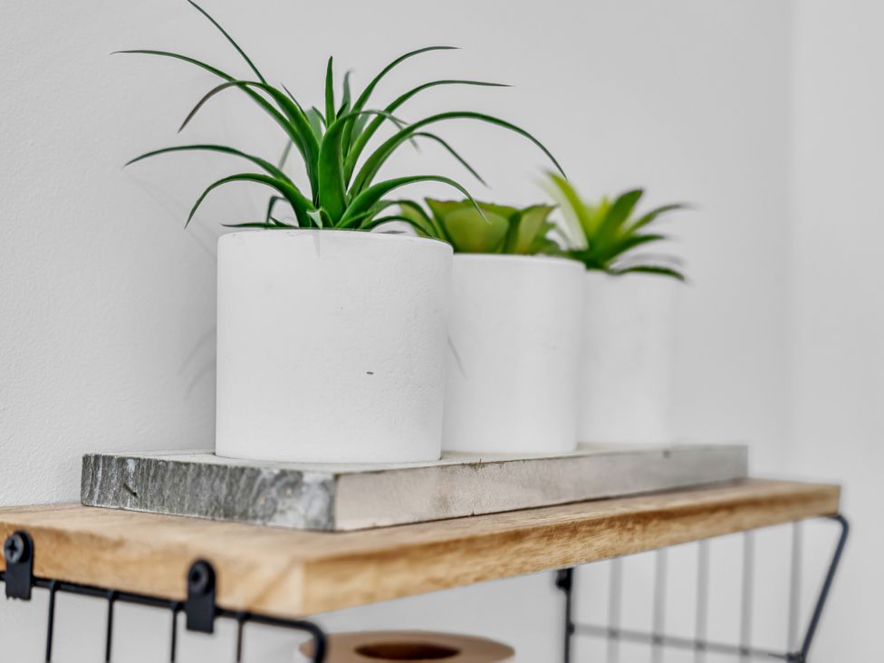 Potted plants on a wooden shelf at Peak View Terrace